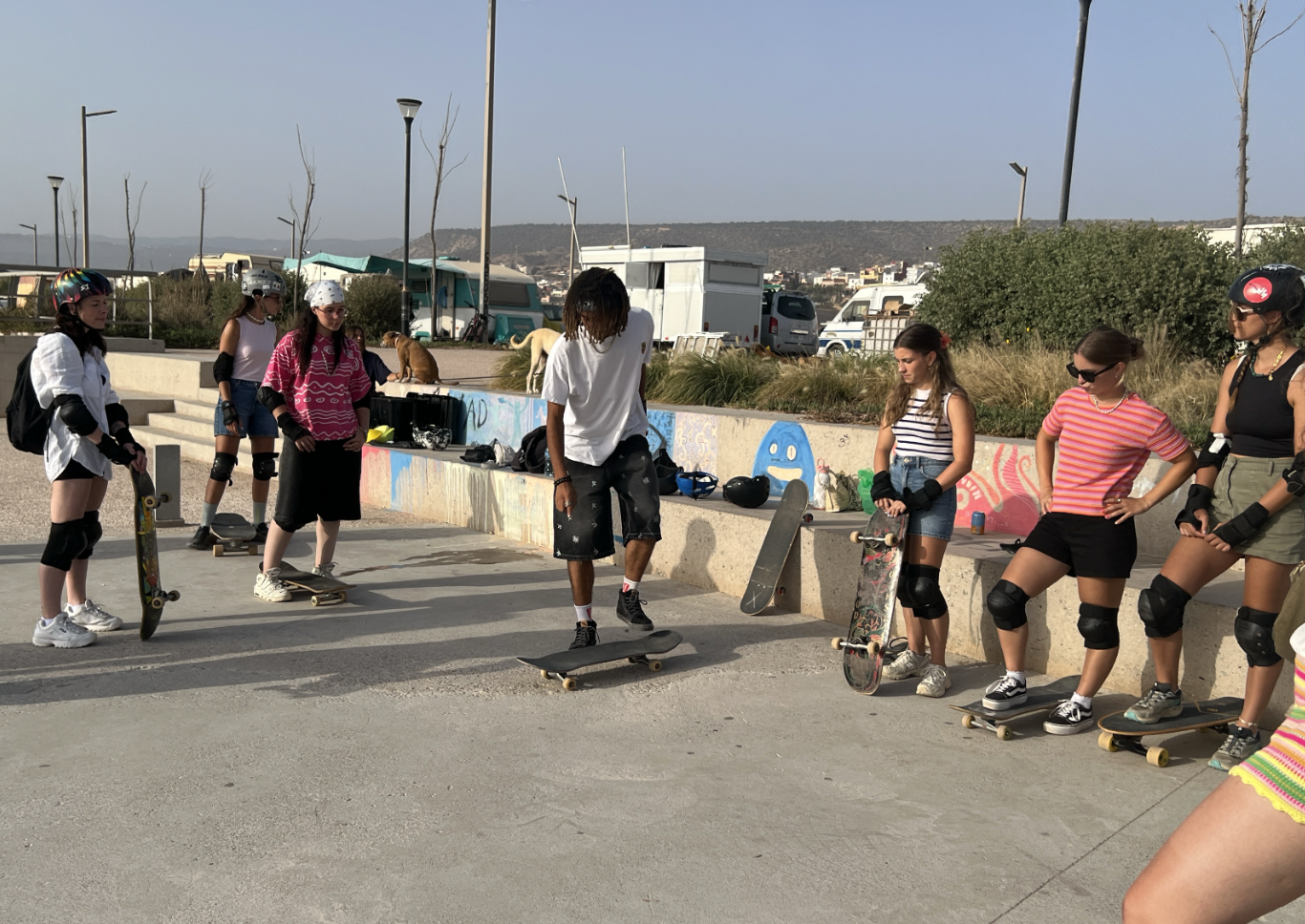 Casa Skate Club group of young skaters in helmets and pads during a camp, school or hotel session at an outdoor skatepark